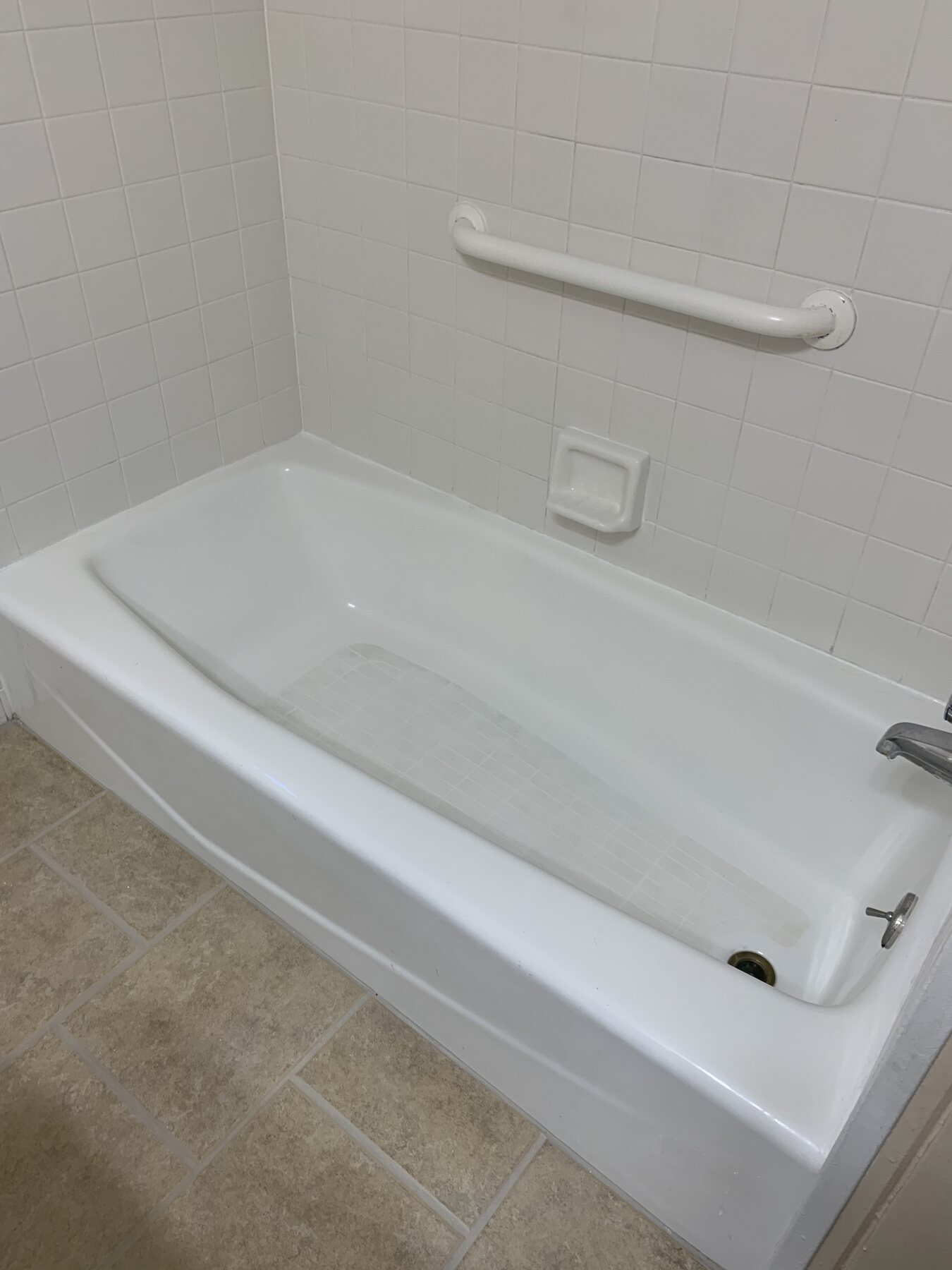 Restored shower and tub with clean white tile and grout